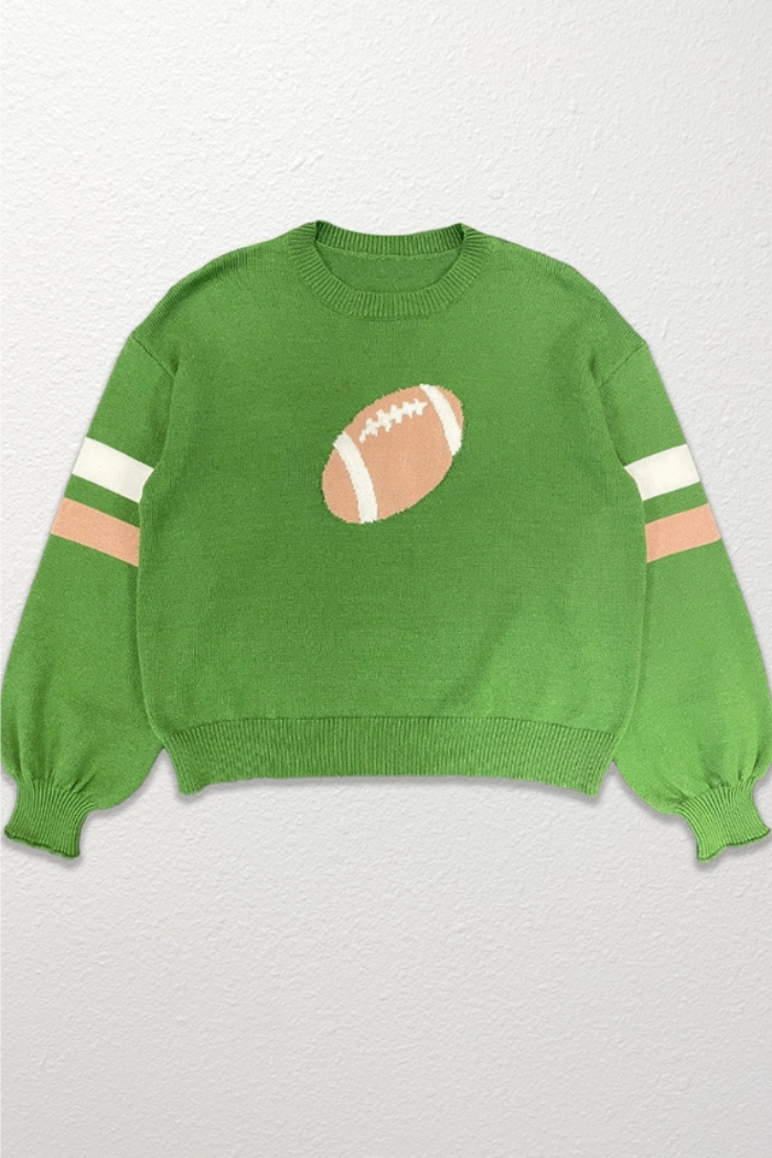 A green knit sweater featuring a large football graphic on the front and two horizontal stripes on each sleeve (one white, brown). The sweater has a round neckline and gathered cuffs.