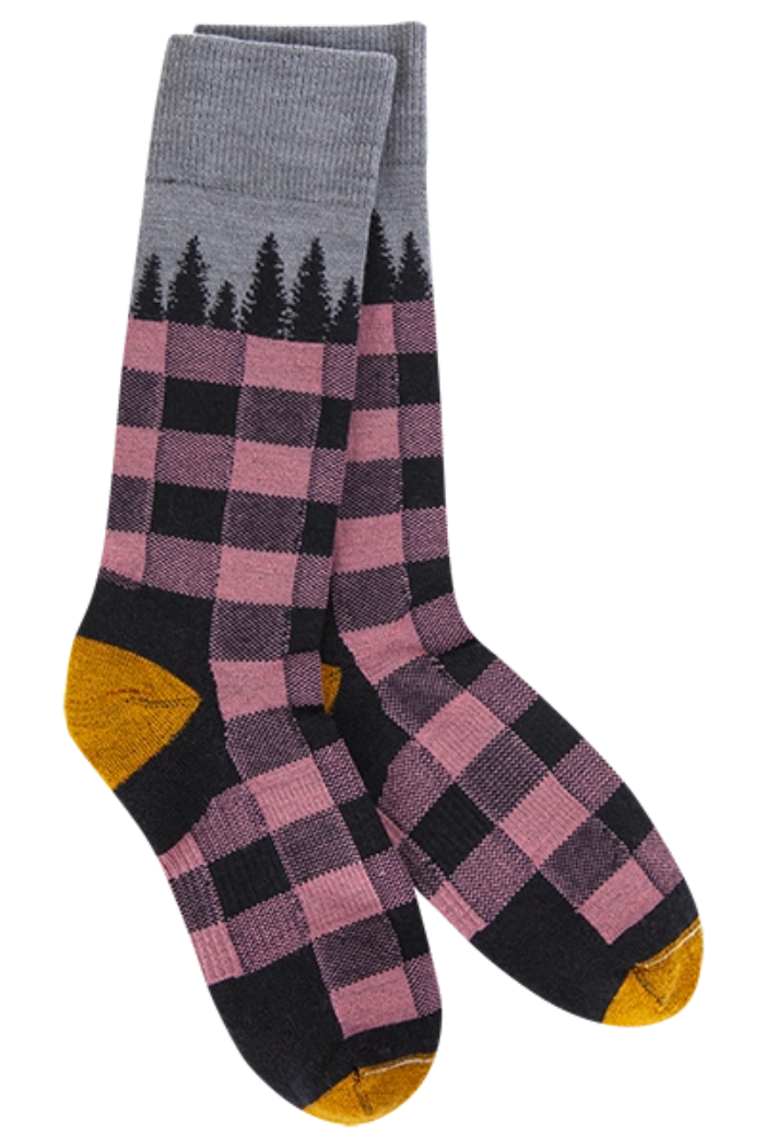 "A pair of women's sock wool socks in navy tree plaid pattern with pink and black checks, a grey cuff featuring a black tree silhouette design, and mustard yellow accents on the heel and toe."