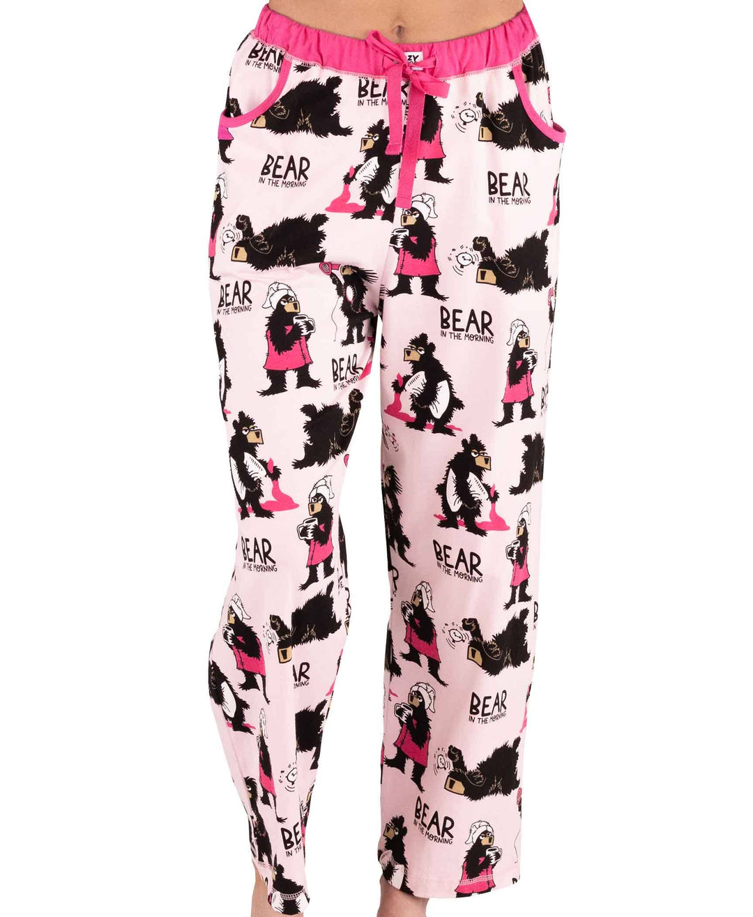 Someone wearing Dog Mom, Cat Nap & More Pajama Pants—light pink cotton with bear and girl cartoon prints, "BEAR in the morning" text, novelty graphics, and a pink drawstring waist.