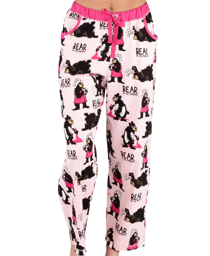 Someone wearing Dog Mom, Cat Nap & More Pajama Pants—light pink cotton with bear and girl cartoon prints, "BEAR in the morning" text, novelty graphics, and a pink drawstring waist.