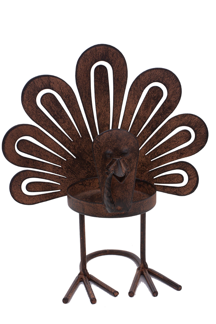 A rustic brown metal turkey candle holder with a fanned tail, textured body, and a holder for a small candle at its center. The turkey's head and wattle are prominent features.