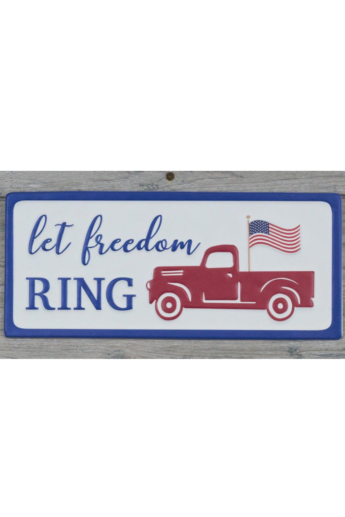 The Let Freedom Ring Metal Sign features a red vintage truck with an American flag on a white background and blue border—ideal for adding patriotic flair to your decor.