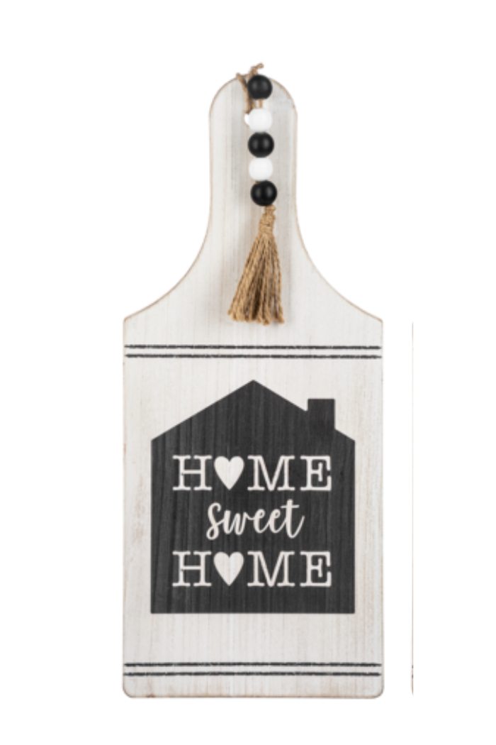 Decorative sign with 'Home Sweet Home' text and a tassel on a white background