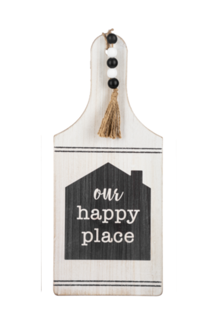 Decorative cutting board with 'our happy place' text on a white background