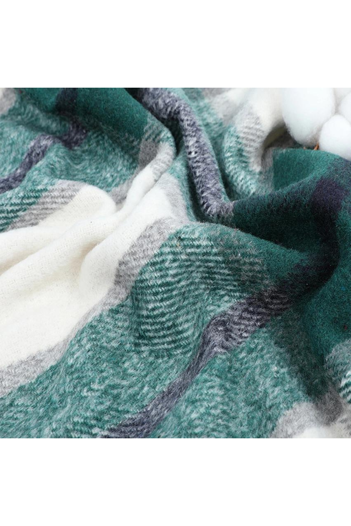 Close-up of a textured fabric with green, white, and purple colors.