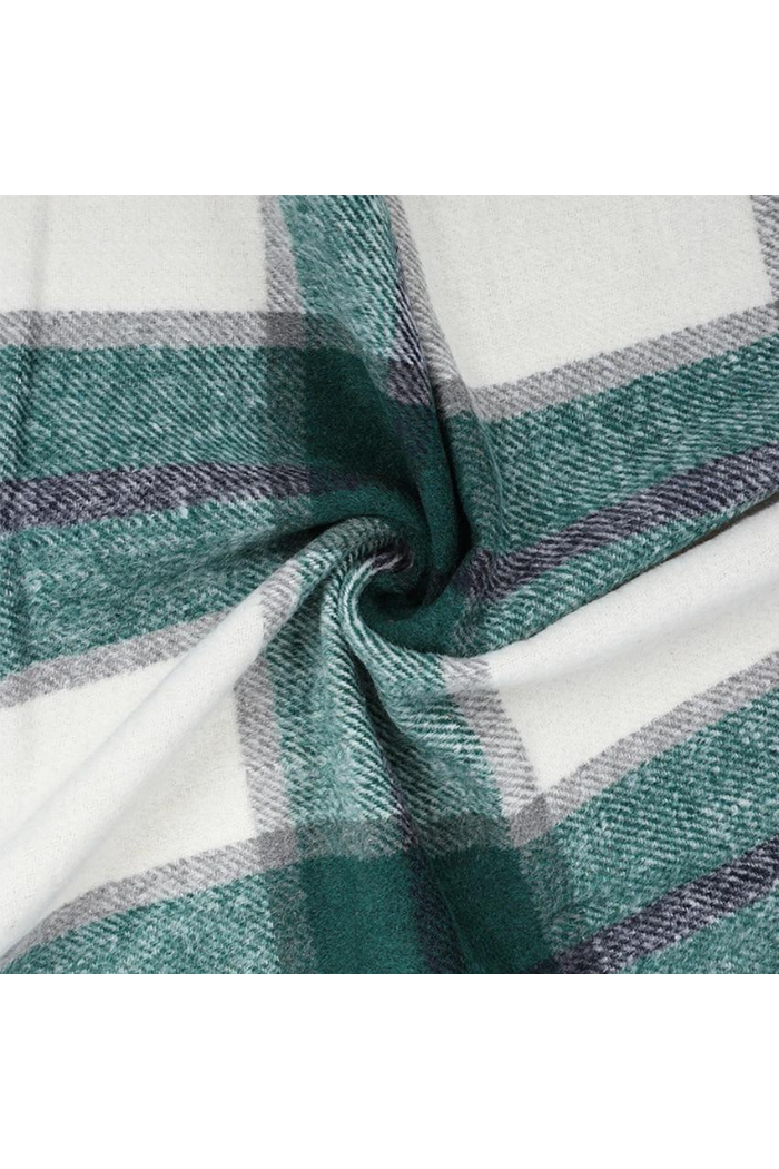 Close-up of a plaid fabric with green, purple, and white colors.