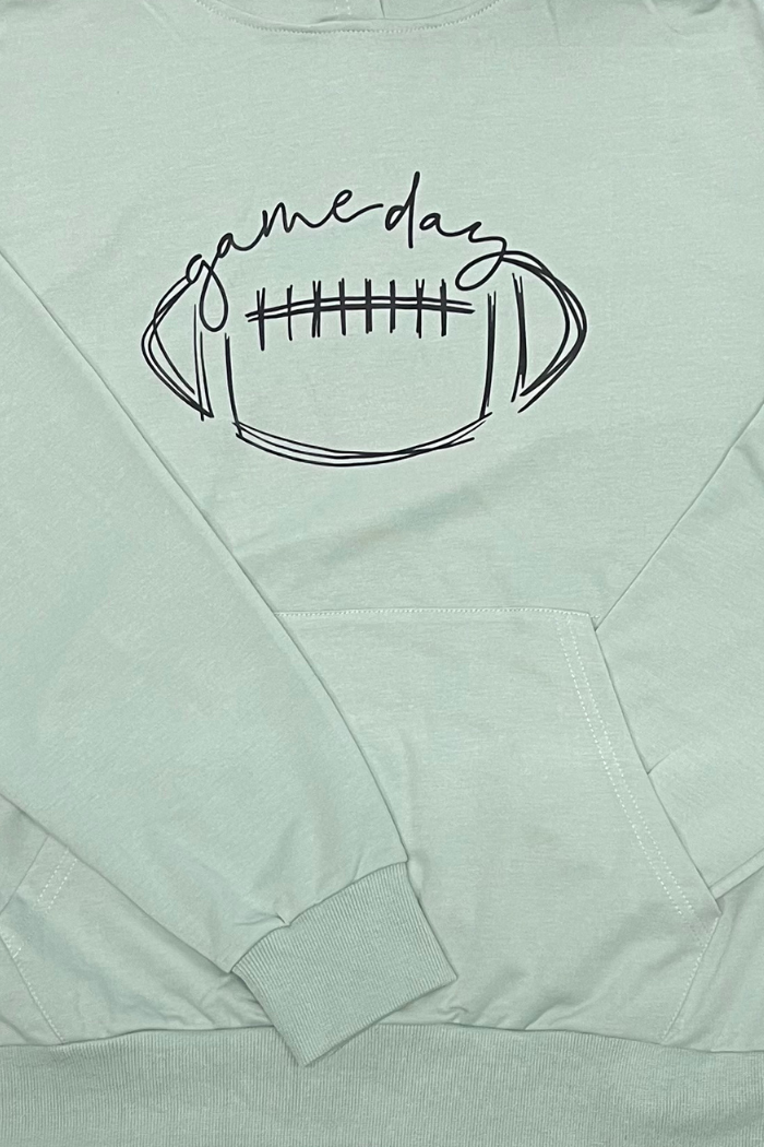 A light green long-sleeved hoodie with a large black graphic of a football and the words "game day" written above it in a script font. The hoodie has a front pocket.