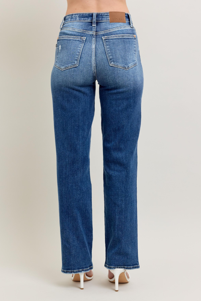 Back view of a pair of dark wash Judy Blue High Waist 90's Straight Leg Jeans, showcasing the straight fit through the leg and the high-rise waist.