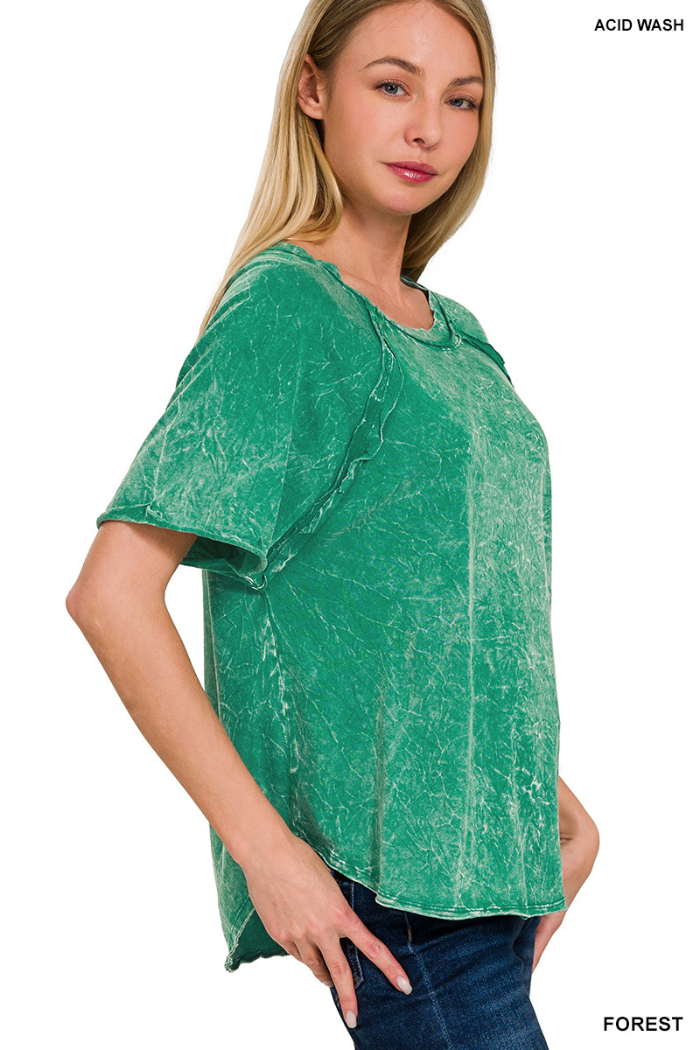 A woman wearing a green acid-washed short-sleeve top. The text "ACID WASH" is in the top right corner and "FOREST" is in the bottom right corner of the image.

