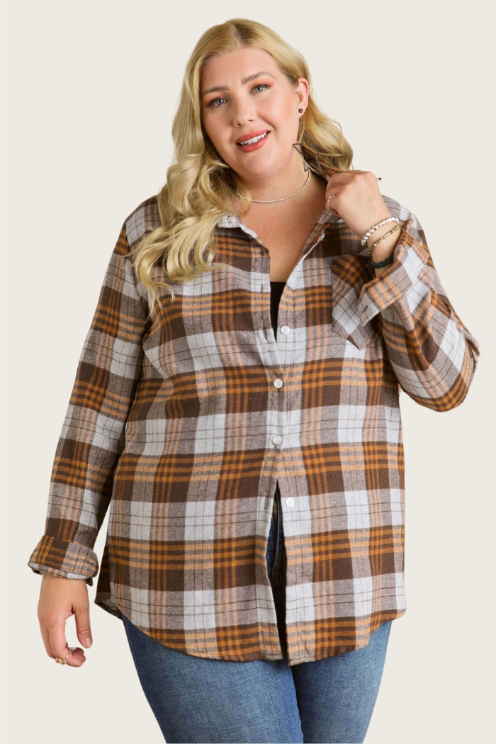 The image shows a woman wearing an oversized brown plaid flannel shirt. This style of shirt often features. Plaid pattern: In this case, a brown and grey color scheme.