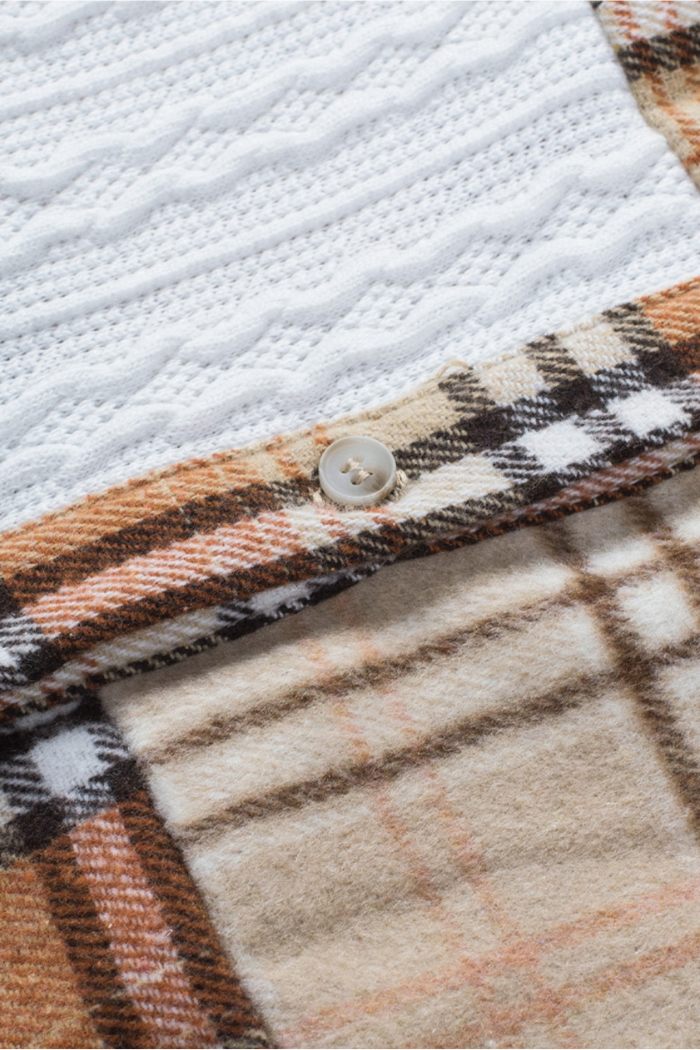 A close-up of a women's plaid color-block patchwork shirt jacket, featuring a brown and tan plaid pattern with a white cable-knit texture on the upper portion, and a single light-colored button visible on the plaid fabric. 