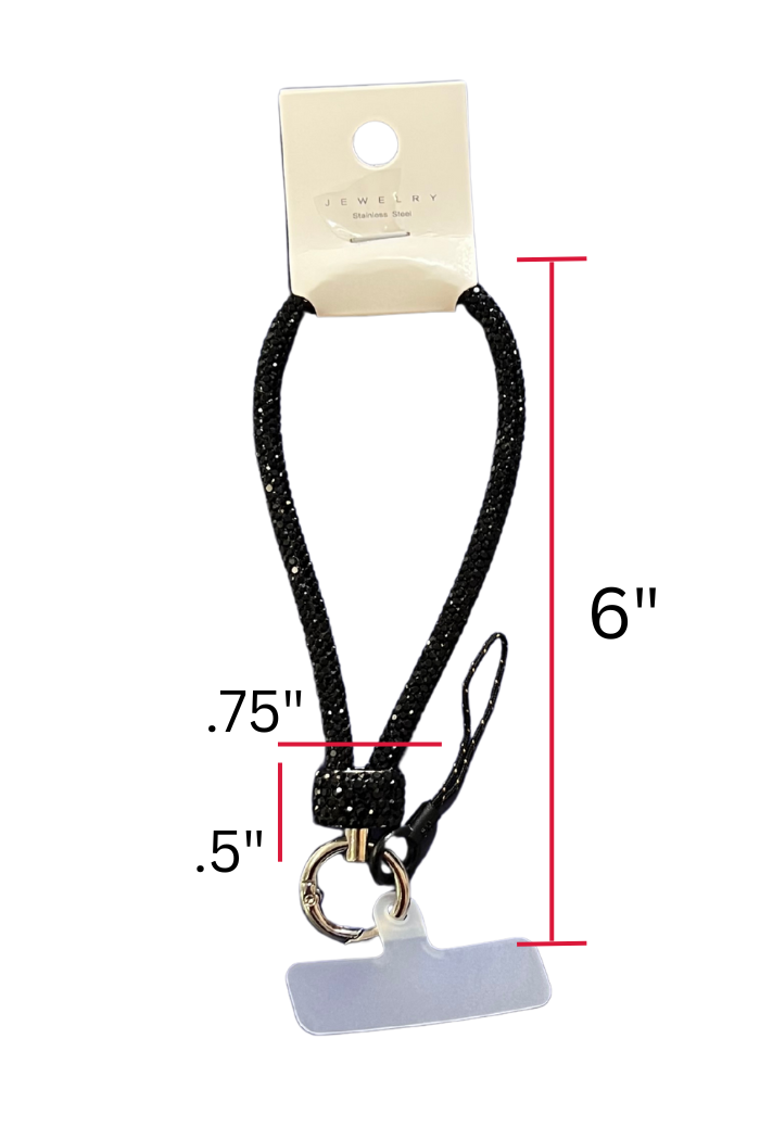 A black, glittery wrist strap or short lanyard for a phone or keys is displayed against a white background, hanging from a small cardboard tag labeled "JEWELRY." Red lines and text indicate the dimensions: the total hanging length of the strap is 6 inches, the width of the loop at its base is 0.75 inches, and the length of the attached clear plastic tether tab is 0.5 inches. The strap features a silver-colored split key ring and a black cord loop with a clear plastic tether tab for attaching to a phone case