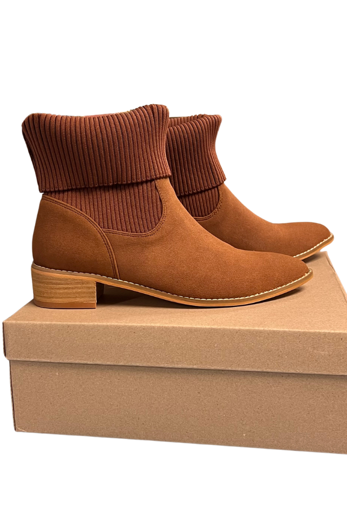 A pair of brown Folded Knit Ankle Booties with ribbed knit cuffs and low block heels is displayed on a closed cardboard shoe box.