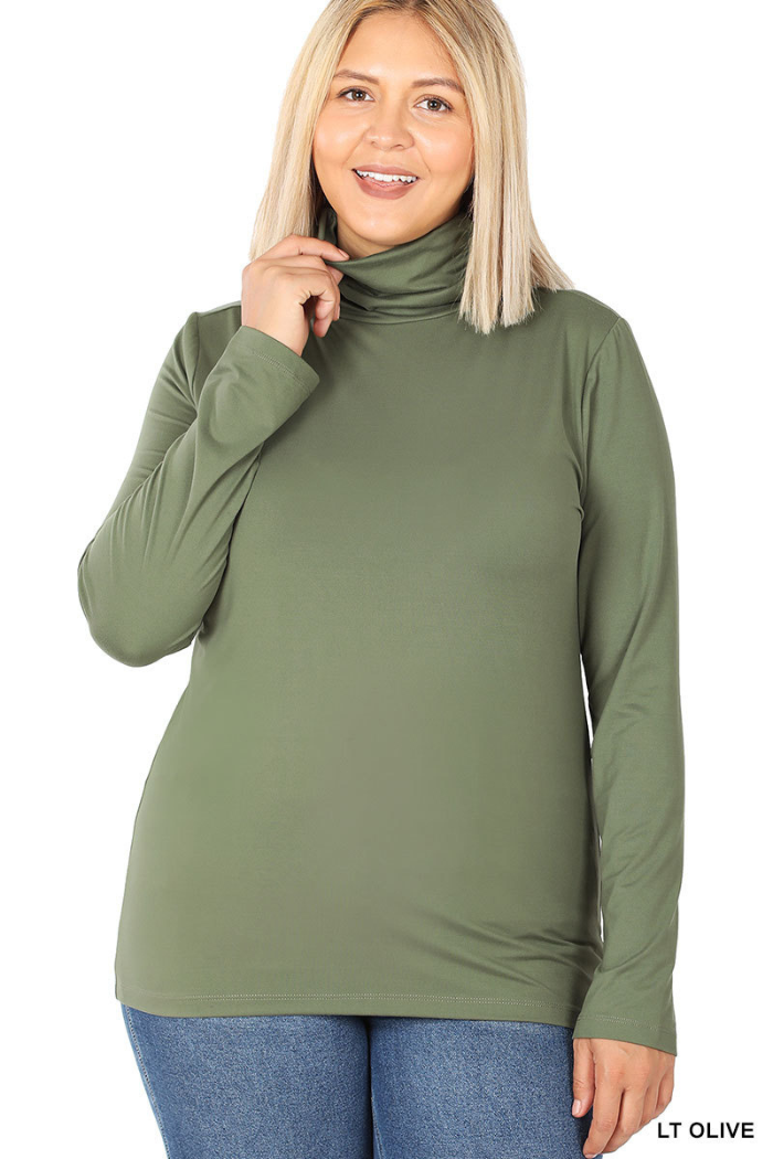 Smiling woman with straight blonde hair wears the Plus Premium Microfiber Mock Neck Top in light olive green and blue jeans, standing against a white background.