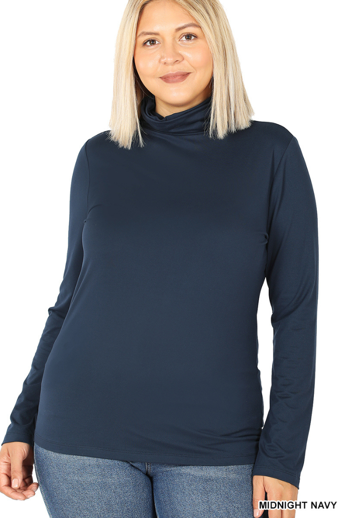 A woman with straight blonde hair wears the Plus Premium Microfiber Mock Neck Top in midnight navy with blue jeans, standing against a white background.