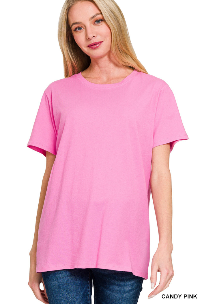 A woman with long blonde hair is smiling at the camera, wearing a relaxed fit Cotton Basic Tee and blue jeans. The words CANDY PINK appear in the bottom right corner.