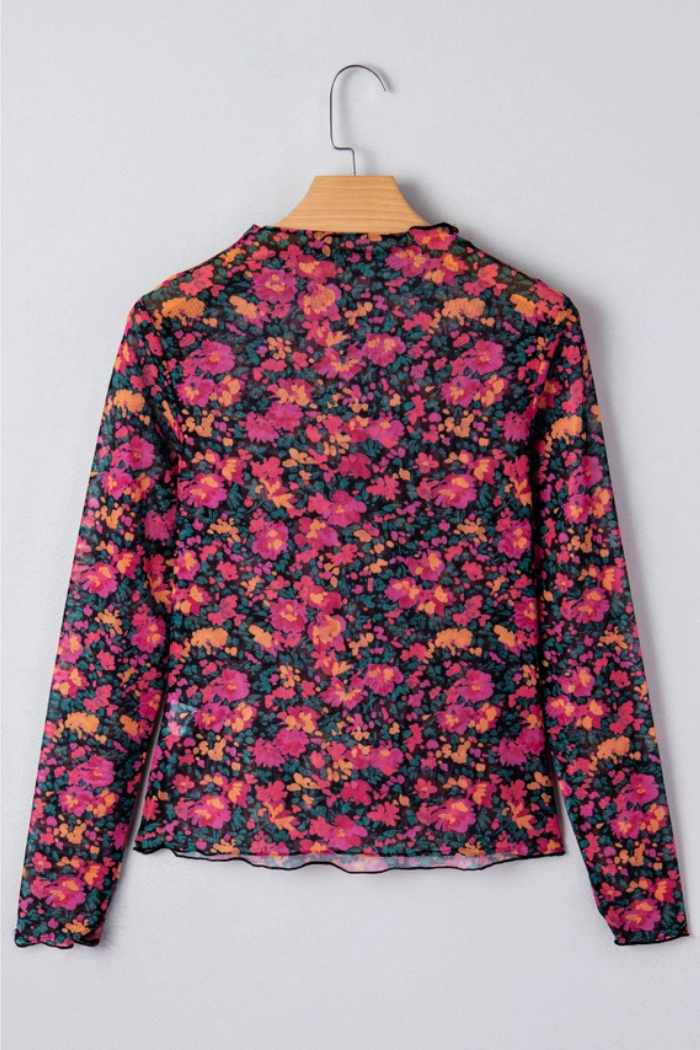 The Floral Mock Neck Top, made from lightweight mesh with a vibrant pink, red, orange, and green floral print, is shown on a wooden hanger against a light gray background.