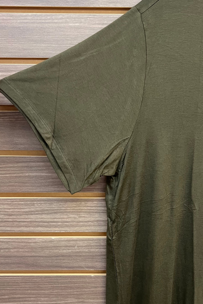 A Plus Size Rayon Tee in olive green, made from a soft blend, is shown hanging against a wooden slat wall with the left sleeve and shoulder in focus.
