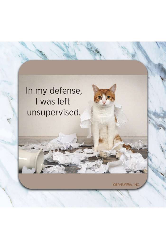 A cat sits among torn paper and a fallen cup on marble, looking up. Next to it: "In my defense, I was left unsupervised." A hilarious scene perfect for the Retro Humor Drink Coasters collection.