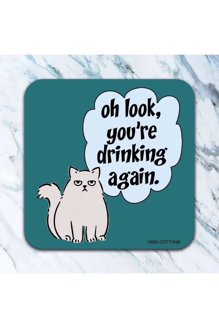 Retro Humor Drink Coasters feature a grumpy cat and the phrase "oh look, youre drinking again." With a teal background and marble surface, these funny coasters add charm and humor to your table.