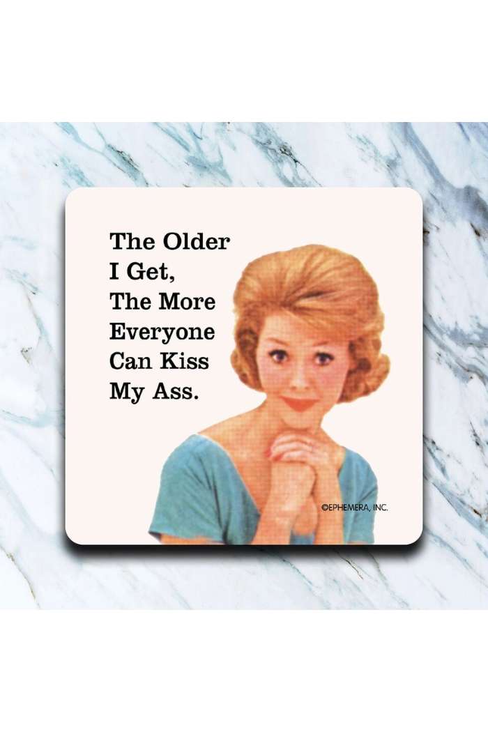A retro-style image of a smiling woman in a blue top with the text: The older I get, the more everyone can kiss my ass. A witty addition to your Retro Humor Drink Coasters collection.