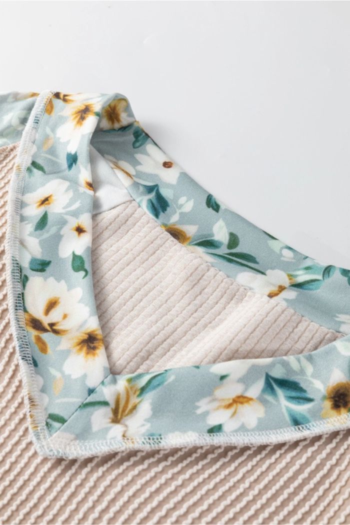 Close-up of the Floral Contrast Ribbed Top in beige with a white and yellow floral pattern and light blue trim, displayed against a white background.
