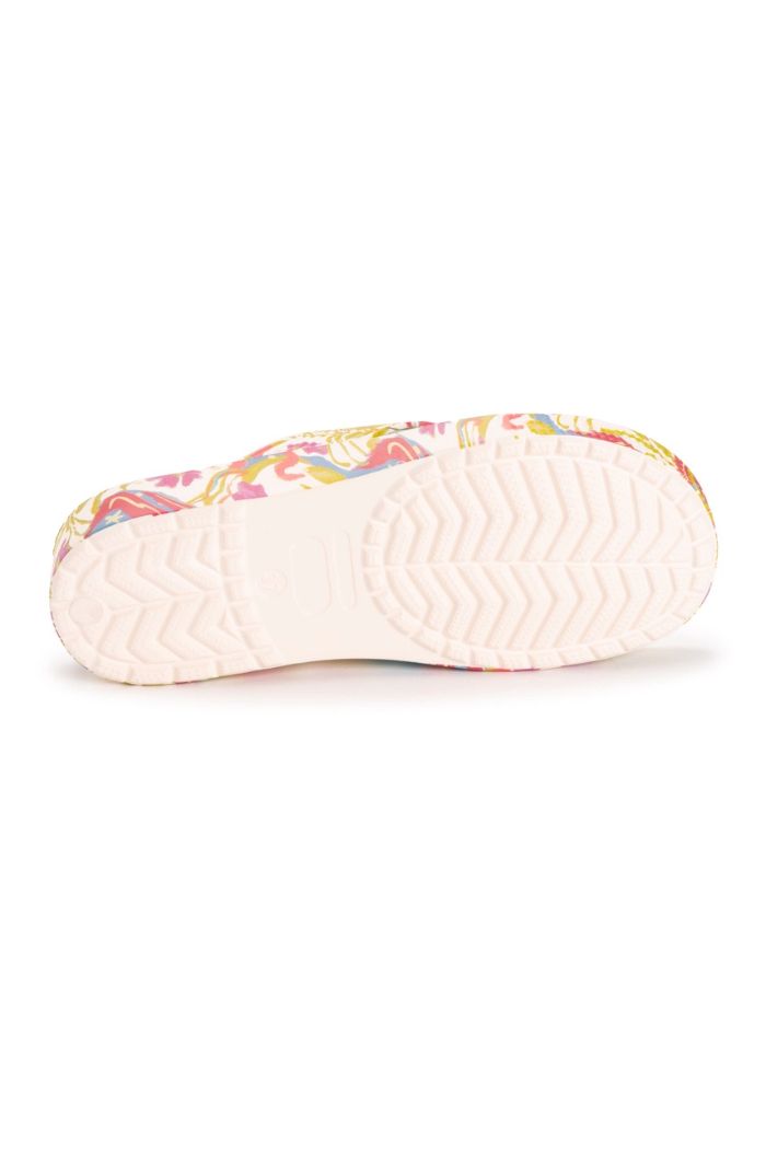 The image shows the Women's Turquoise Spa Sandals with a light pink sole featuring zigzag and hexagonal tread, colorful floral sides, and cushioned footbeds for comfort in these slip-on slides.