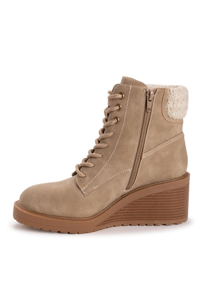 Sky Solange Wedge Boots in light brown feature a lace-up front, side zipper, white stitching, and a textured ankle cuff. These stylish faux leather wedge boots are shown on a plain white background.
