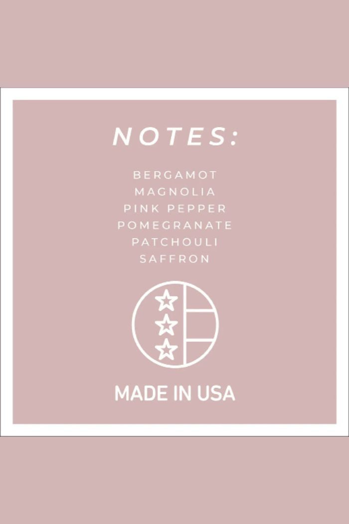 The Papa 34oz Candle features a pink square label listing notes of bergamot, magnolia, pink pepper, pomegranate, patchouli, and saffron. Beneath the label is a circular USA emblem reading MADE IN USA.