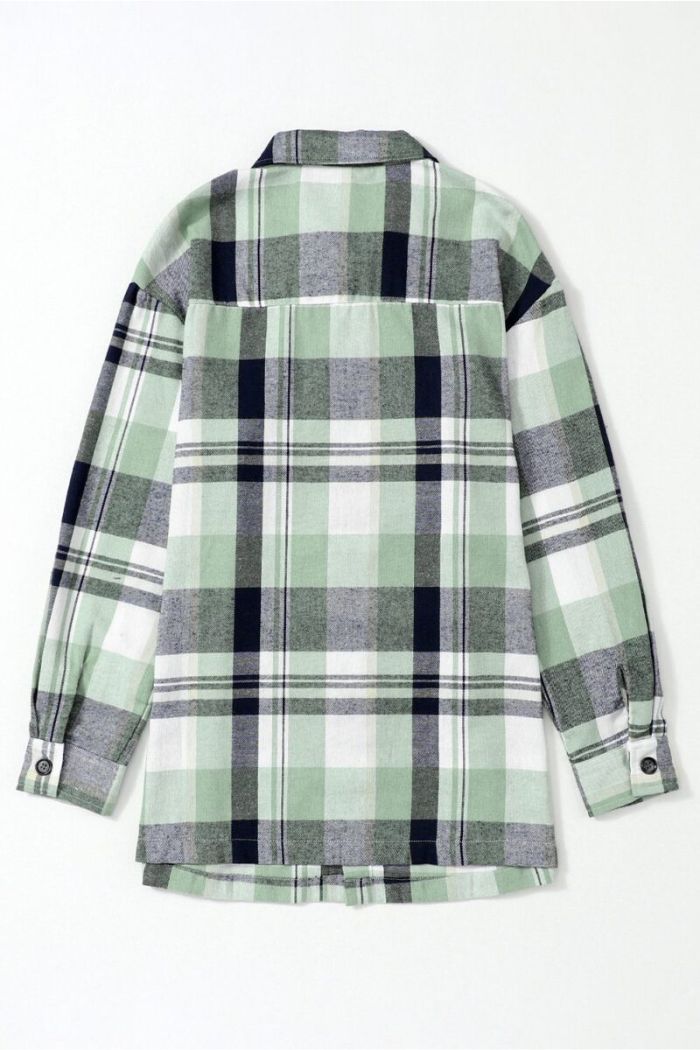 A Plaid Button Up Shirt with long sleeves and button cuffs in a green, black, white, and gray plaid pattern is shown laid flat with the back facing up on a white background.