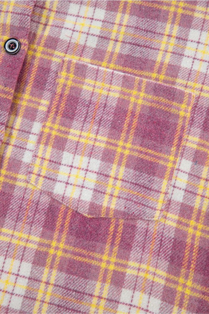 Close-up of the Pink Plaid Shacket, highlighting the chest pocket and button detail. The fabric has intersecting pink, yellow, and white lines—ideal for layering as a casual shacket in transitional weather.