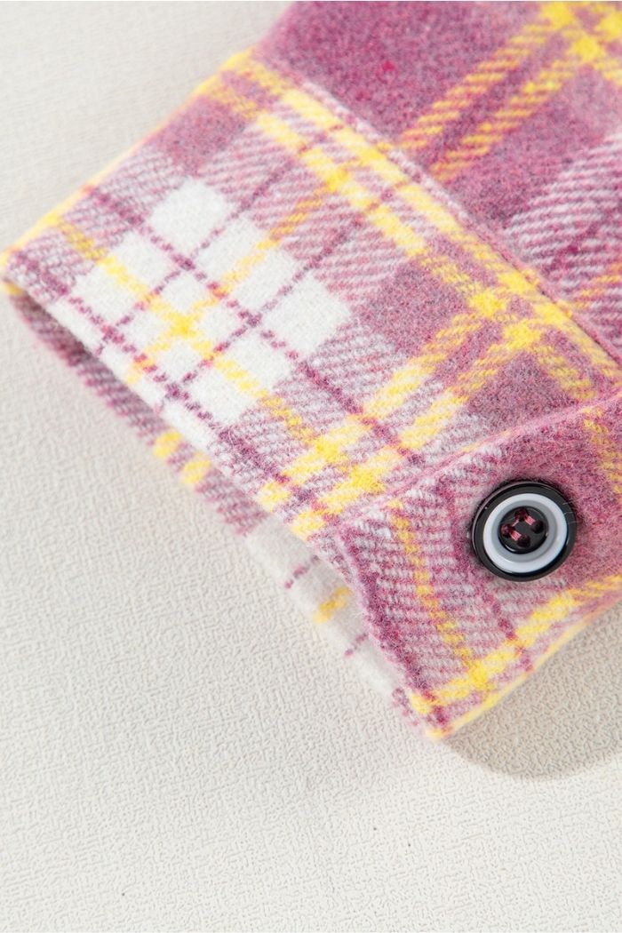 Close-up of the Pink Plaid Shacket cuff, featuring pink, yellow, and white plaid fabric with a black and white button—perfect for effortless layering as a women's casual transitional jacket.