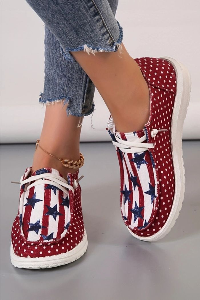 Someone wearing Americana Mash Print Sneakers with a red, white, and blue stars-and-stripes design, paired with frayed hem blue jeans.