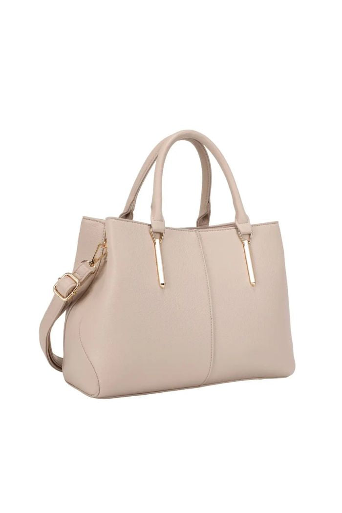 The Corina Satchel Bag features beige vegan leather, gold-tone hardware, double handles, and a detachable shoulder strap, shown against a white background.