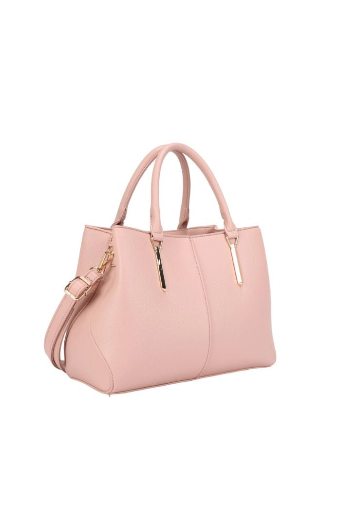 The Corina Satchel Bag is a light pink structured handbag with gold hardware, two top handles, and an adjustable shoulder strap, made from vegan leather and shown against a plain white background.