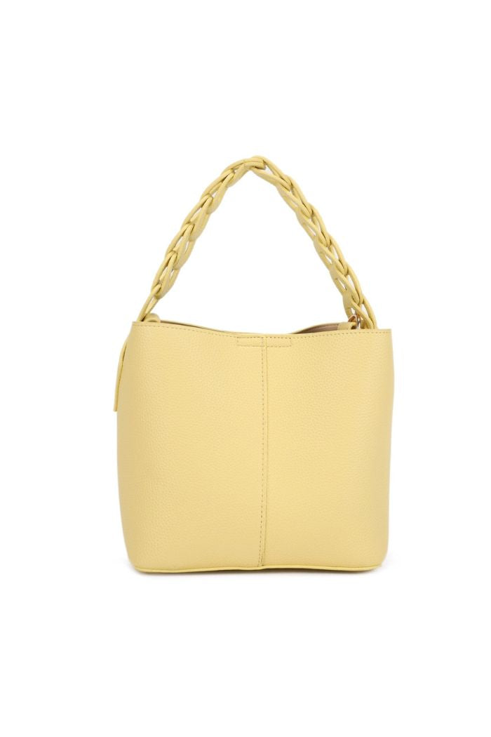 The Lorna Crossbody Bag features a yellow, textured faux leather surface and a thick braided handle. Its compact, structured shape adds modern elegance, displayed upright against a plain white background.