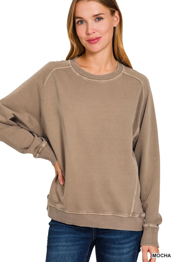 A woman wearing a relaxed fit, enzyme-washed tan Pigment Dye French Terry Sweatshirt with ribbed cuffs and hem.