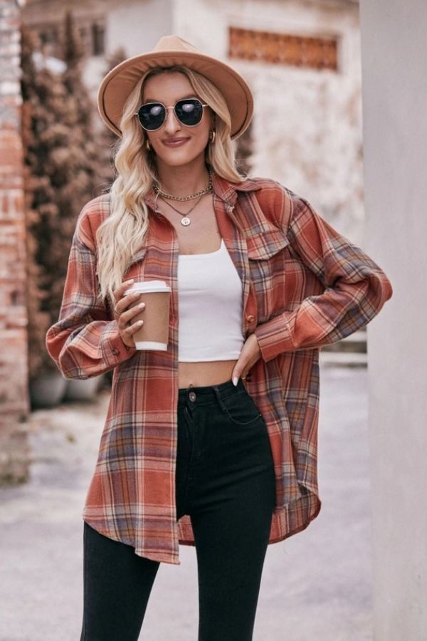 A woman with long blonde hair, wearing sunglasses and a tan hat, styles the Oversized Plaid Button Shirt over a white crop top and black pants. She holds a paper coffee cup and smiles outdoors.