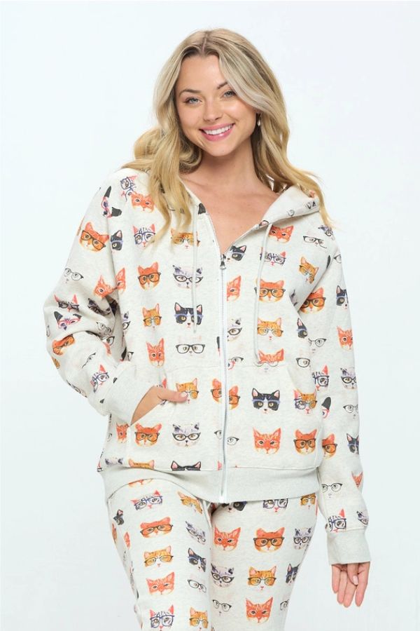A woman wearing a Cats in Glasses Zip Hoodie featuring an all-over print of various cats wearing eyeglasses.