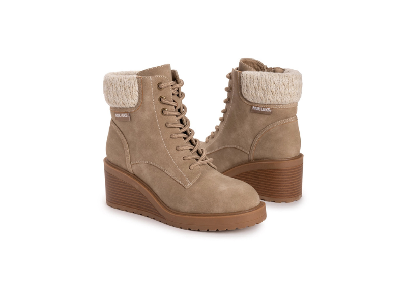 Pair of beige boots with brown soles on a white background