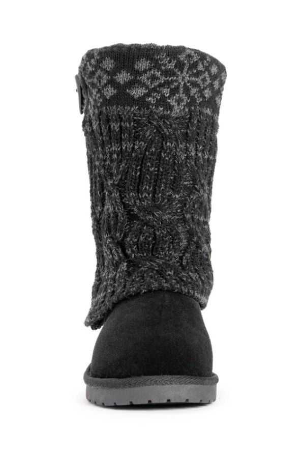 Black mid-calf MUK LUKS Cheryl Toggle Boots with a cable-knit, snowflake-patterned cuff, side toggle closure, and faux fur lining.