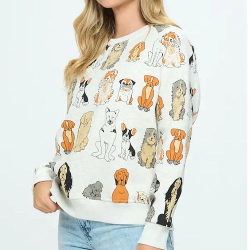 A woman models the Dog Print Crewneck Sweatshirt—a light-colored pullover adorned with illustrated dog breeds—paired with light blue jeans. The photo is cropped above her nose, highlighting the sweatshirt’s charming design and making it an ideal gift for dog lovers.