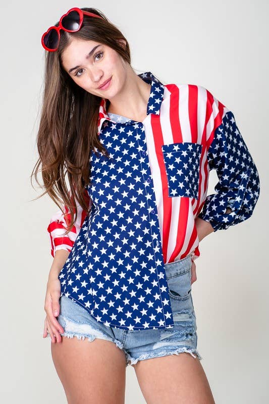A woman wearing red heart-shaped sunglasses, a Patriotic Button Shirt, and ripped denim shorts poses against a plain background.