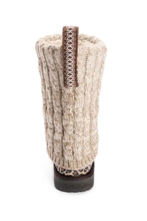 Back view of MUK LUKS Cheryl Leopard Boots, featuring a tan cable-knit design, a leopard print heel, and a vertical patterned pull tab.
