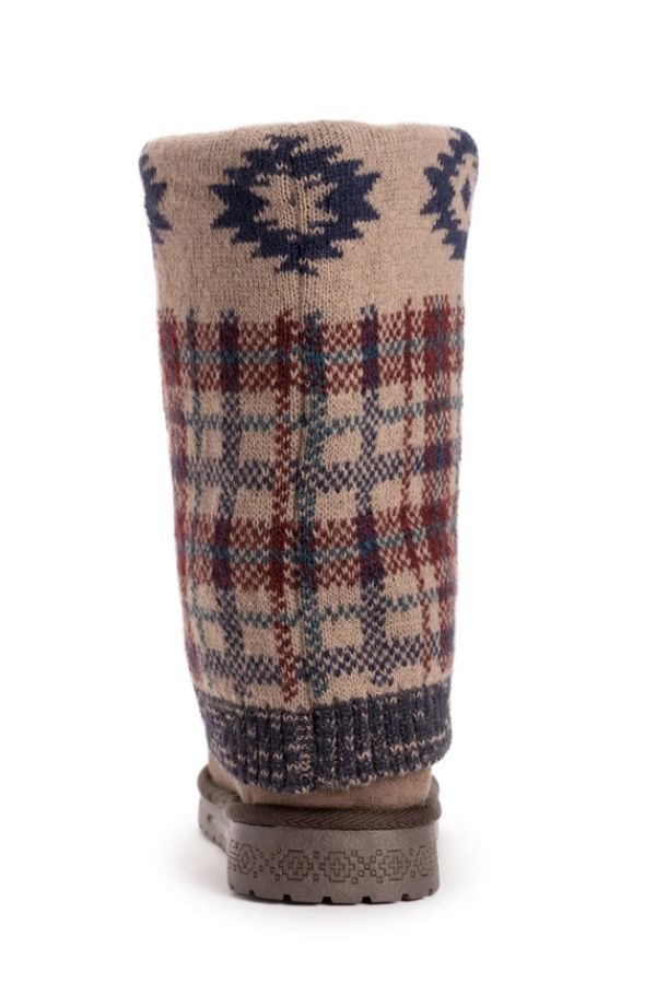 MUK LUKS Cheryl Aztec Plaid Boots, knee-high and water-resistant, featuring a tan knitted shaft with a blue Aztec pattern at the top, a red and blue plaid print below, and a dark brown rubber sole.