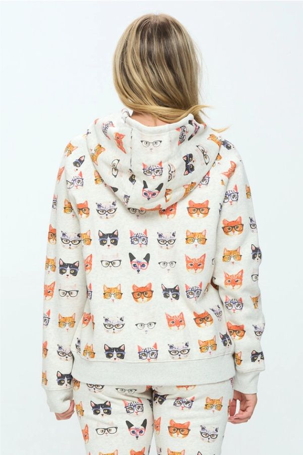 Back view of a person wearing a Cats in Glasses Zip Hoodie and matching pants, both featuring an all-over print of cat faces wearing various styles of glasses.