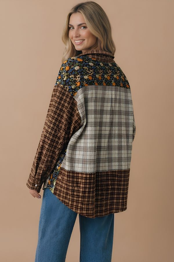 Wearing the Curvy Patchwork Button Down Top featuring loose, floral and plaid patterns—perfect for fall layering—a woman pairs it with blue jeans, poses against a beige background, and smiles over her shoulder.