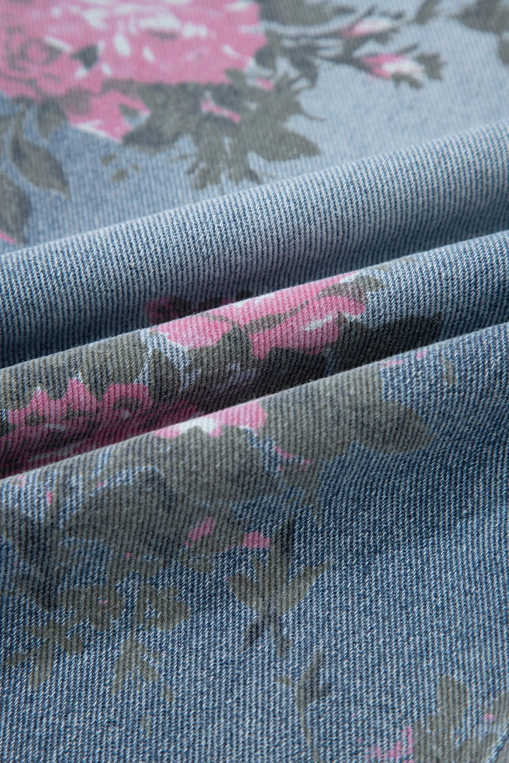 Close-up of Floral Pull-On Jeans in blue denim with pink and gray flowers, featuring textured folds—ideal for comfortable pull-on or relaxed straight-leg styles.