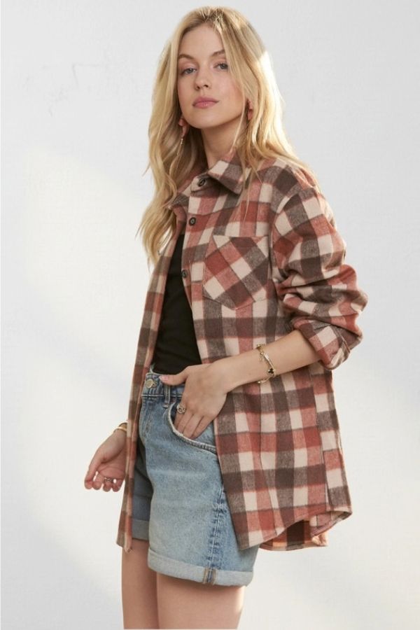 A woman wearing a relaxed fit brown and cream Plaid Wool Blend Shacket over a black tank top and denim shorts.