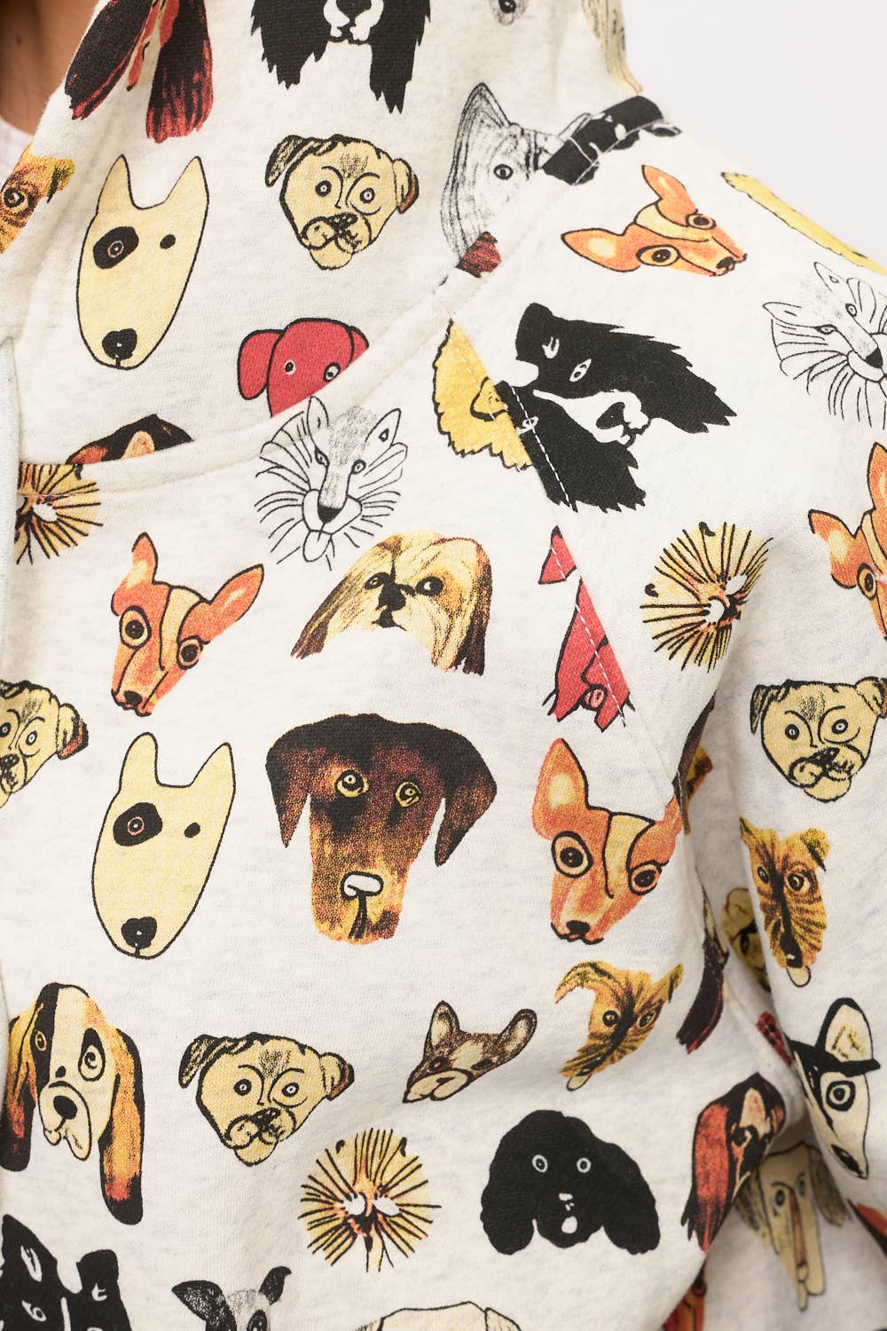 A close-up of the COLORFUL DOG FACES PRINT ZIP UP HOODIE, featuring a playful pattern of vibrant cartoon dog faces—ideal for fans of unique and fun dog lover apparel.